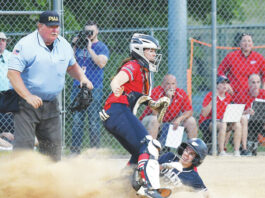 
			
				                                Abington Heights’ Marley Sarafinko slides underneath Patriots catcher Ava Callahan before the throw to the plate to score the first run of Tuesday night’s district title game at Wilkes.
                                 Tony Callaio | For Times Leader

			
		