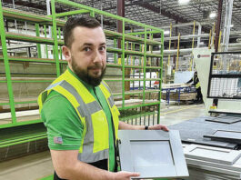 
			
				                                Damian Gawronkiewicz, head of manufacturing operations at Wren Kitchens, holds one of the many styles of kitchen cabinetry the company manufactures in two large buildings in the Hanover Industrial Estates in Hanover Township and Sugar Notch and Warrior Run boroughs.
                                 Kerry Miscavage | Times Leader

			
		