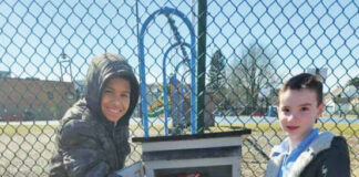 
			
				                                Matthew Williams and Angelo Alba place their book donations in the collection container located at the Duryea park.
 
			
		