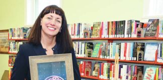 
			
				                                West Pittston Library Director Maria Grzybowski, an artist in her own right, holds one of her paintings entitled, “Flower of Life” along with “Raven’s Call” on the easel which will be auctioned off as a part of the West Pittston Library Art Auction on May 25. Tickets can be purchased at the Front Desk of the Library during business hours.
                                 Tony Callaio | For Sunday Dispatch

			
		