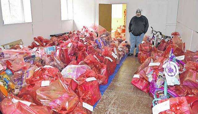 
			
				                                The Greater Pittston Santa Squad founder Anthony Marranca stands amidst hundreds of bags filled with toys designated by Angel donors at a temporary warehouse for the 2021 Christmas campaign.
                                 Tony Callaio | For Sunday Dispatch

			
		