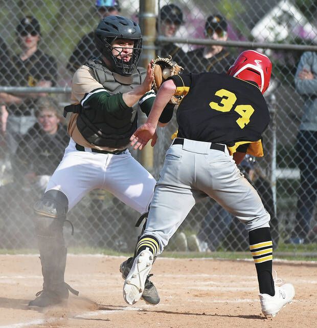 Wyoming Area catcher Jeremy Layland is about to put the tag on Lake-Lehman's Andrew Mathis before slipping at home.  Tony Callaio |  For Sunday shipping